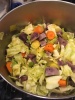 Tikil gomen (to be) A pot containing cabbage, potatoes, and carrots, not yet cooked.
