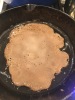 Injera A piece of injera (flatbread) cooking in a cast-iron skillet